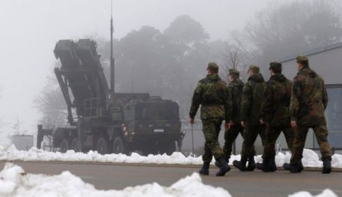 German soldiers walk past a PAC-3 launcher in December 2012 (Photo source: Reuters).